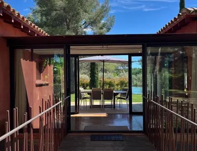 an open glass door of a house with a table and chairs at Petite Toscane Villa close to Aix en Provence in Ventabren