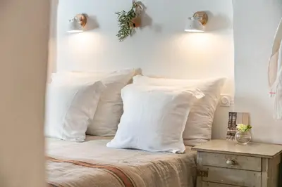 a bedroom with white pillows on a bed at Chez Prunelle in Flassan