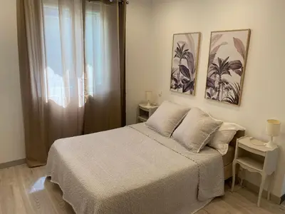 a bedroom with a bed and two pictures on the wall at Résidence Soleado Maison jumelée à 800m du centre ville de Bédoin in Bédoin