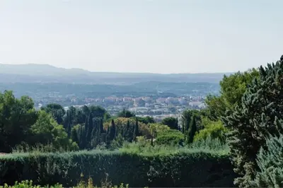 a view of a city from a hill with trees at Bastide vue exceptionnelle in Aix-en-Provence