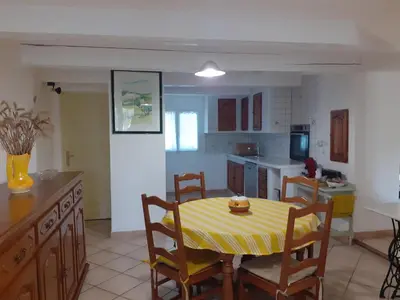 a kitchen and dining room with a table and chairs at Mas provençal in Sénas