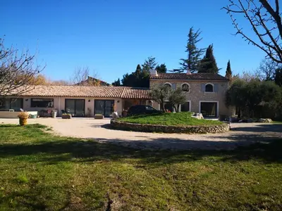 a house with a car parked in front of it at Mas Paolo Gite de charme en Provence Piscine in Le Thor