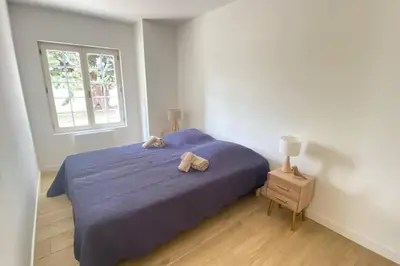 a bedroom with a blue bed and a window at Gite Nature & Bien-Être avec piscine in Lincel