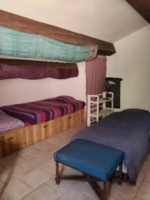a bedroom with two bunk beds and a blue bench at Soleil bleu in Rognes