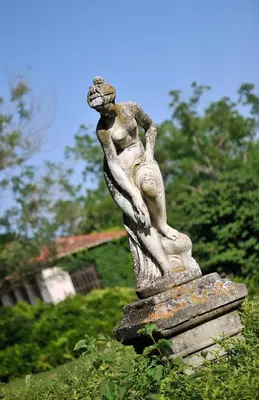 a statue of a woman standing on a rock at Demeures et Châteaux Hôtel L'Hermitage in Pernes-les-Fontaines