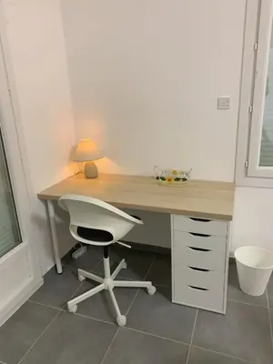 a desk with a white chair and a lamp at Villa Les Cigales Velaux in Velaux
