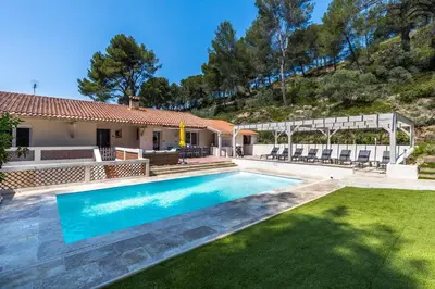 a swimming pool in the yard of a house at Villa Les Cigales Velaux in Velaux