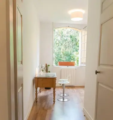 a room with a table and a window and a stool at Spacieux T3 * centre ville * sans vis à vis in Aix-en-Provence