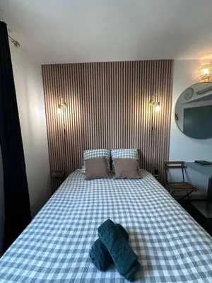 a bedroom with a bed with two towels on it at Joli Studio le clos d'Aix avec grande terrasse piscine et parking gratuit in Aix-en-Provence