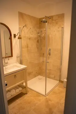 a bathroom with a shower and a sink at La maison du bassin in LʼIsle-sur-la-Sorgue