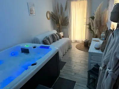 a living room with a tub in the middle of it at Cocon Classé 3 Etoiles - Love et Détente - SPA in Carpentras