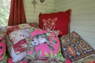 a pile of pillows sitting on a bed next to at Vent de Bohème in Cabannes