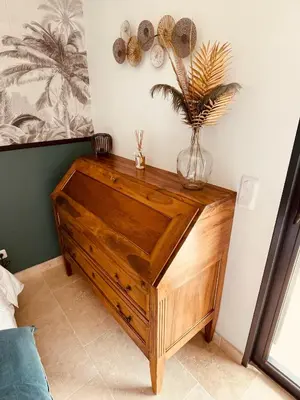 a wooden cabinet with a vase on top of it at Gite La Madeleine du Luberon. in Lioux