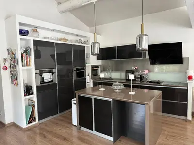 a kitchen with black cabinets and a counter top at Villa climatisée avec piscine à St Remy in Saint-Rémy-de-Provence