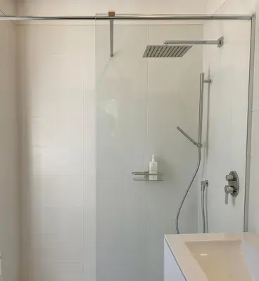 a shower with a glass door next to a sink at Maison, Jardin, piscine parking près d'Aix Centre in Venelles
