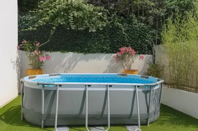 a bath tub sitting on the grass with plants at Maison, Jardin, piscine parking près d'Aix Centre in Venelles