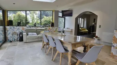 a living room with a wooden table and chairs at Coin de paradis en Provence in Sault-de-Vaucluse