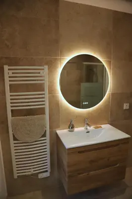 a bathroom with a sink and a mirror at Duplex de charme au coeur de la Provence. in Pertuis