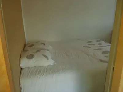 a small bed in a room with two pillows at Location provence ventoux sault in Sault-de-Vaucluse