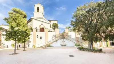 a building with a steeple and a church at Village Pont Royal en Provence - maeva Home - Appartement cosy et climatisé 2 pièces 4 personnes - Prestige - super Home MAE-2164 in Mallemort