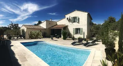 a house with a swimming pool in front of a house at Villa tout confort, piscine - Au pied du VENTOUX in Saint-Didier