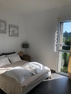 a bedroom with a bed and a large window at Appartement Aix en Provence vue Ste Victoire - BATIMENT B11 - 13090 AIX EN PROVENCE in Aix-en-Provence