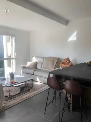 a living room with a couch and a table at Appartement Aix en Provence vue Ste Victoire - BATIMENT B11 - 13090 AIX EN PROVENCE in Aix-en-Provence