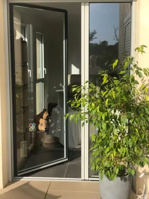 a sliding glass door with a potted plant at Appartement Aix en Provence vue Ste Victoire - BATIMENT B11 - 13090 AIX EN PROVENCE in Aix-en-Provence