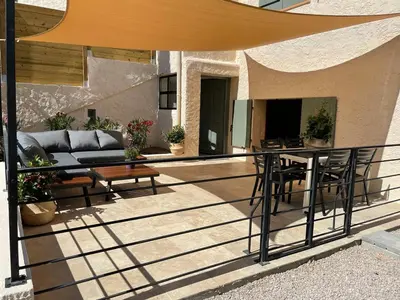 a balcony of a house with a couch and a table at La Ribasse en Provence in Venelles