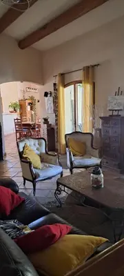 a living room with two chairs and a coffee table at La Ribasse en Provence in Venelles