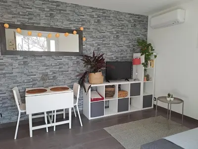 a living room with a table and a tv at La Ribasse en Provence in Venelles