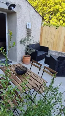 a patio with a couch and a table and chairs at La calade in Vedène