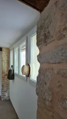 a room with a window and a stone wall at La calade in Vedène