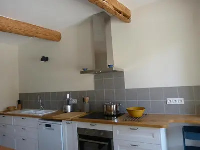 a kitchen with white cabinets and a counter top at Gite du domaine Saint-Marc, entre Ventoux et dentelles de Montmirail in Caromb