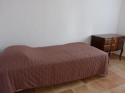 a bedroom with a bed and a night stand at Gite du domaine Saint-Marc, entre Ventoux et dentelles de Montmirail in Caromb