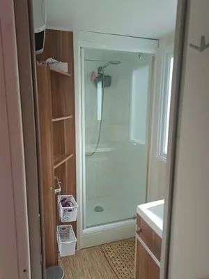 a bathroom with a shower with a glass door at MOBIL HOME LMNP GUIGON in La Roque-dʼAnthéron