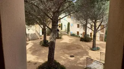 an empty courtyard with trees and a building at Village Pont Royal en Provence - maeva Home - Appartement climatisé 2 pièces 6 personnes - Confort MAE-1684 in Mallemort