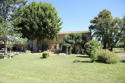 a house with trees and a grass yard at La Bastide au coeur de la Provence in Pertuis