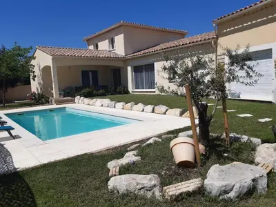 a house with a swimming pool in the yard at Olympe de Provence in Caromb