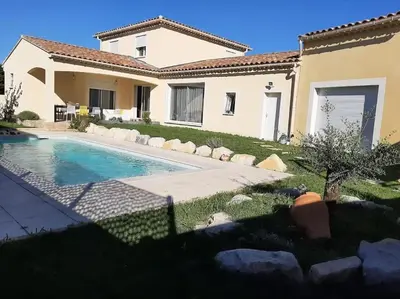 a house with a swimming pool in the yard at Olympe de Provence in Caromb