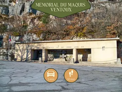 a building with two signs in front of it at Sault Tropical - Idéal couple - Balnéo Led - Vue parc & montagne - Wifi - Stationnement gratuit - 5min à pied des bars, restaurants & commerces in Sault-de-Vaucluse