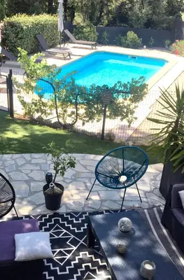 a patio with chairs and a swimming pool at Villa avec Piscine au coeur de la campagne provençale in Lançon-Provence