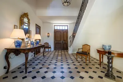 two white beds in a room with bookshelves at Le Domaine du Fortin in Ménerbes