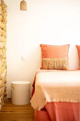 a small bedroom with a bed and a table at La Maison des Lamanon in Salon-de-Provence