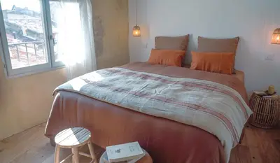 a bedroom with a large bed and a window at La Maison des Lamanon in Salon-de-Provence