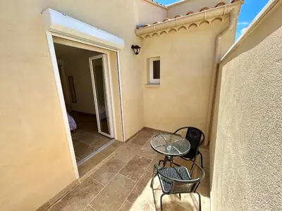 a balcony with a table and chairs in a room at Maison de charme avec Jacuzzi in Mollégès