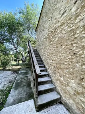 a stone wall with a staircase next to a building at Ravissant appartement à 5min du centre ville d'Aix in Aix-en-Provence