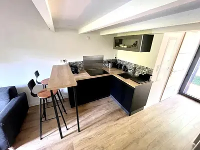 a kitchen with a counter and a table in a room at Ravissant appartement à 5min du centre ville d'Aix in Aix-en-Provence