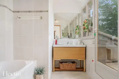 a white bathroom with a sink and a tub and a mirror at Mas du Rocher I Electio in Puget