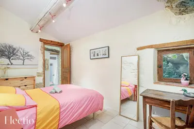 a bedroom with two beds and a mirror at Mas du Rocher I Electio in Puget